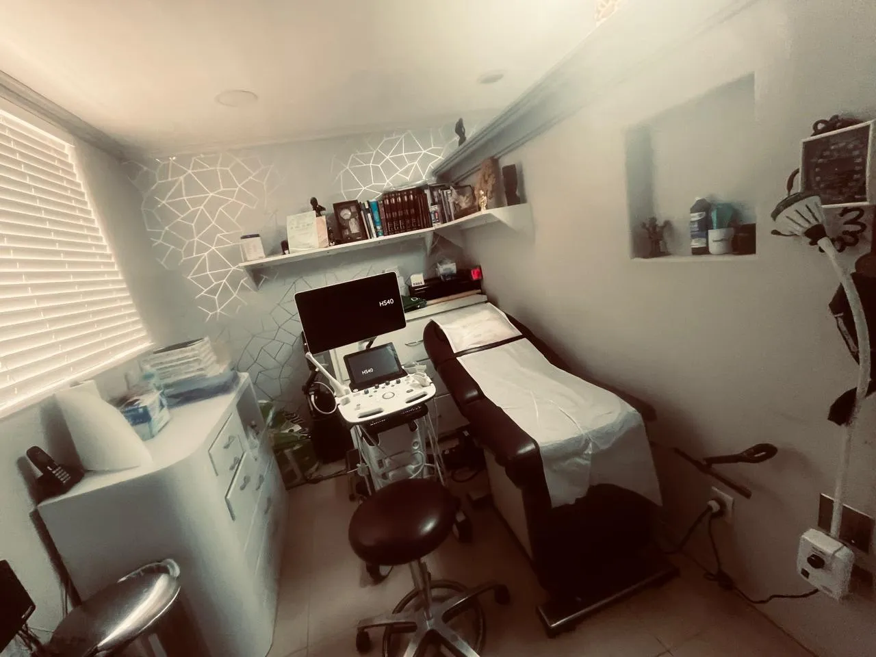 Consultorio con equipo de ultrasonido y mesa de exploración